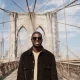 young-stylish-man-exploring-city-bridge-by-himself